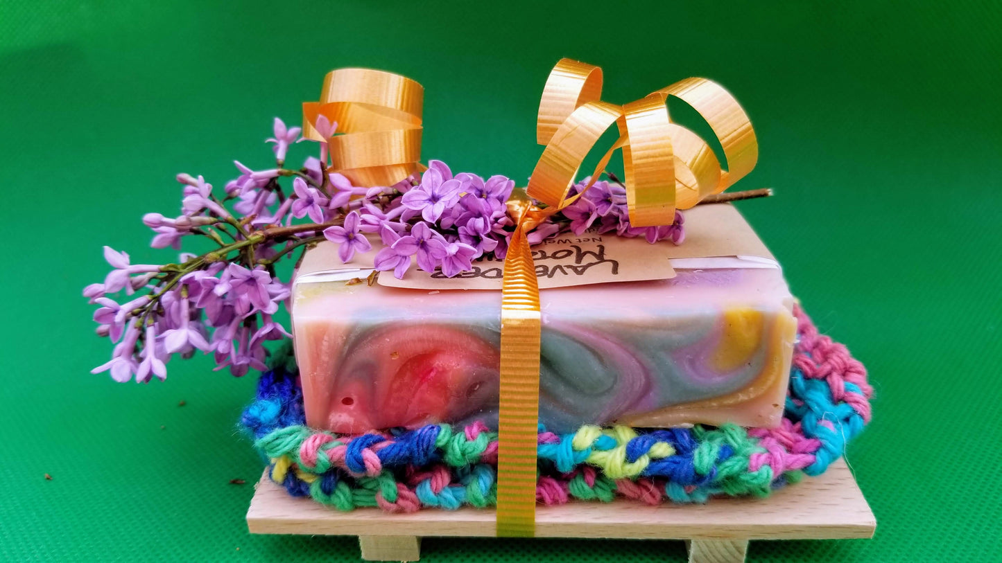 colorful soap bar, and washcloth, tied to a soap dish with a colorful, curly ribbon