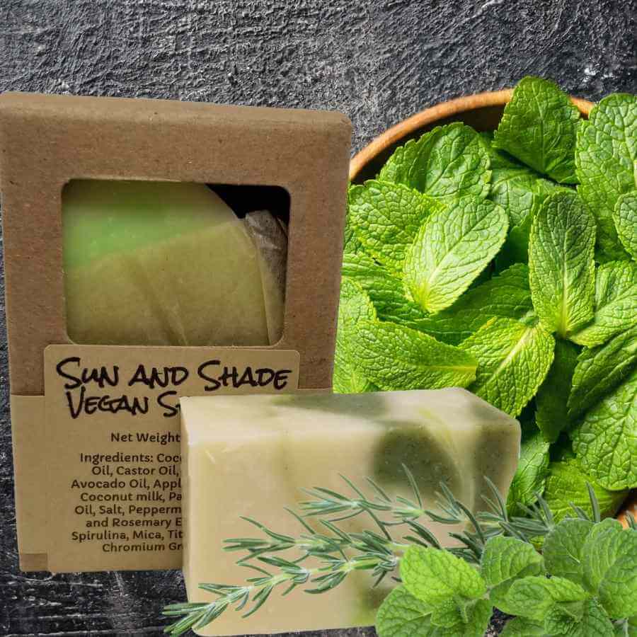 green and white soap with mint leaves and rosemary